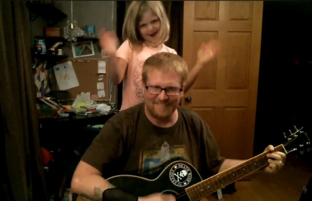 Nathan Ellingson and daughter playing music together