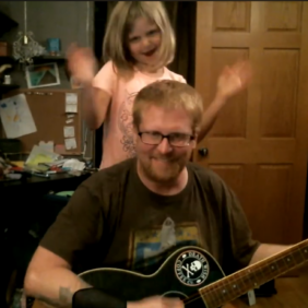 Nathan Ellingson and daughter playing music together