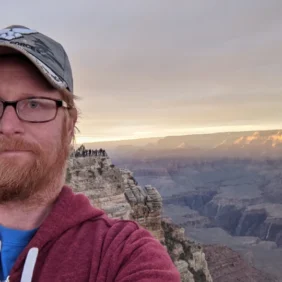 Nathan standing at the Grand Canyon at sunset