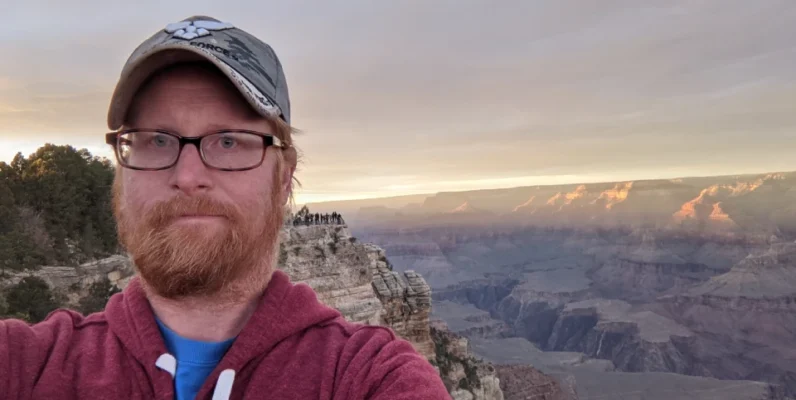 Nathan standing at the Grand Canyon at sunset