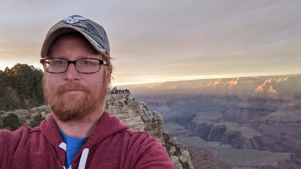 Nathan standing at the Grand Canyon at sunset