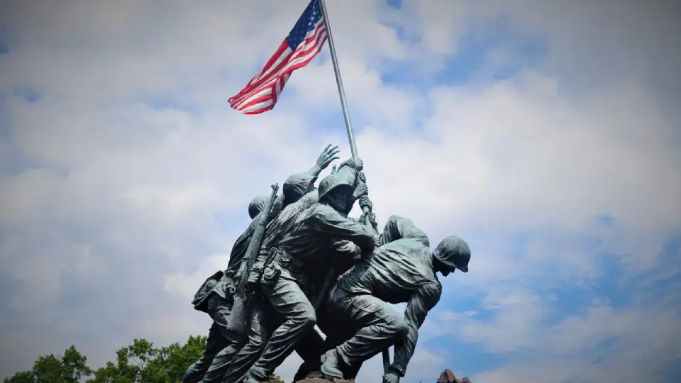 Iwo Jima Memorial depicting soldiers raising the American flag against a blue sky.