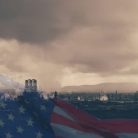 industrial skyline in a bleak clouded world with the american flag fading on top