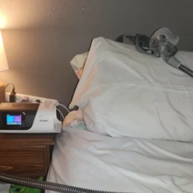 Bed with a CPAP machine next to it.