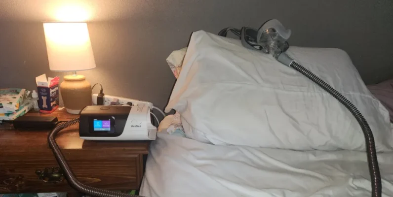 Bed with a CPAP machine next to it.