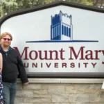 Nathan Ellingson with family standing in front of the Mupunt Mary University sign