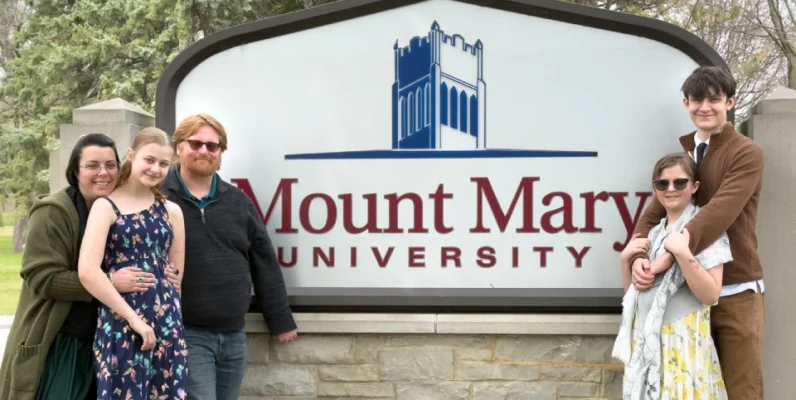 Nathan Ellingson with family standing in front of the Mupunt Mary University sign
