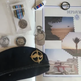 Scrapbook, berets, dogtags, badge, coins, military ribbon, military medal.