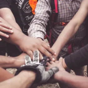 People working together with their hands in a circle