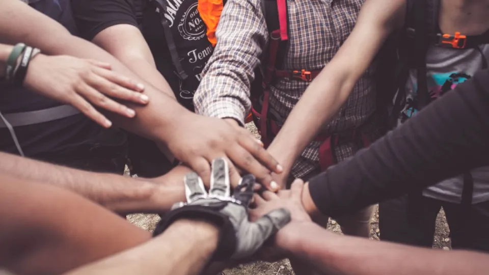People working together with their hands in a circle