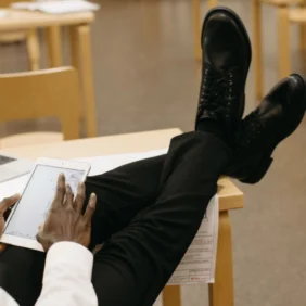 a man sitting and looking at this tablet