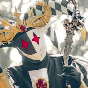 Evil jester with crown and scepter in a crouching position