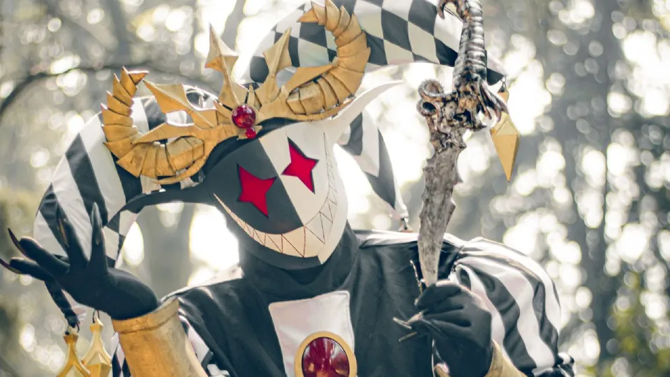 Evil jester with crown and scepter in a crouching position